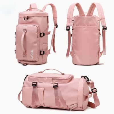 Travel backpack in pink color standing upright