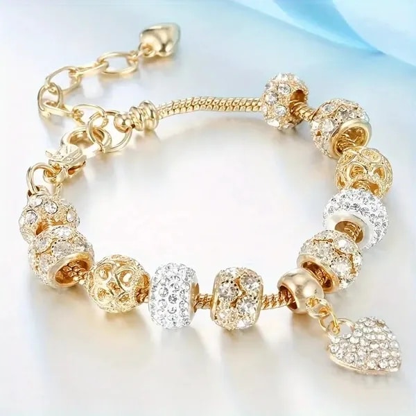 Charm bracelet with gold beads and heart charm
