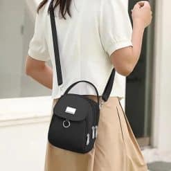 mini crossbody bag black nylon worn by woman